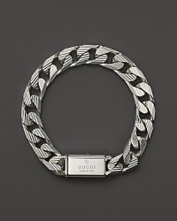 Bold trademark stripes add textural beauty to this sterling silver link bracelet from Gucci.