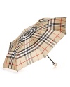 Easily stowed, this classic check umbrella from Burberry boasts endless style in a compact size.