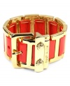 Cuff and ready. This AK Anne Klein bracelet features a belt-inspired stretch design highlighting orange mixed metal set in gold tone mixed metal. Buckle closure. Approximate diameter: 2-1/4 inches.