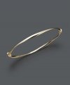 Add a luxurious layer for simple refinement. Bangle features a subtle twist design crafted in 14k gold. Approximate diameter: 2-3/8 inches.