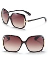 Sleek plastic sunglasses with metal detail and signature logo at temple.