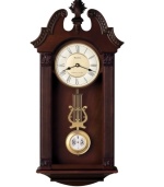 Stunning sophistication. Intricately carved, this walnut-finished wooden wall clock by Bulova features a gorgeous pendulum and plays Westminster or Wittington chimes on the quarter hour. Two-tone metal dial with Roman numerals and two hands features adjustable volume control and night shut-off.