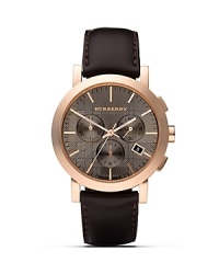 This handsome watch from Burberry features a rose-gold colored case with a subtly textured taupe face, a three-eye analog chronograph dial, and a date window.