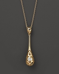 From the Mauresque collection, a teardrop lace-inspired pendant in 18 Kt. yellow gold with diamond pavé. With signature ruby accent. Designed by Roberto Coin.