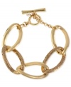 All that glitters is this toggle link bracelet from Kenneth Cole New York. Crafted from gold-tone mixed metal, the bracelet truly sparkles. Item comes packaged in a signature Kenneth Cole New York Gift Box. Approximate diameter: 2-1/2 inches.