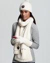 Store away winter's hidden treasures in the pockets of this cozy knit scarf from UGG® Australia.