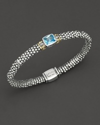 From the Glacier collection, thin caviar rope bracelet with centered blue topaz stone and gold accents. Designed by Lagos.