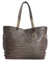 Escape from ordinary accessorizing with this chic carryall from Carlos by Carolos Santana that features a croc-embossed pattern, edgy stud accents and chain-link details.