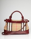 True to form, this Burberry satchel works a classic vibe in printed cotton with a versatile design that is perfect on the arm or across the body.