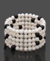 Startling specks of black in a white silhouette. This contrasting cuff will liven up your wardrobe. Bracelet features five rows of black and white cultured freshwater pearls (6-7 mm) in a sterling silver setting. Approximate length: 7 inches.