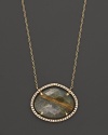 Diamonds circle a faceted rutilated quartz and smoky labradorite doublet set in 18K yellow gold. By Di Massima.