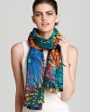 A vibrant tropical forest decorate this sheer oblong scarf from Salvatore Ferragamo.