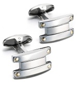 Industrial chic. These unique bar-shaped cuff links feature a sterling silver setting with 18k gold accents. Approximate length: 7/8 inch. Approximate width: 1/2 inch.