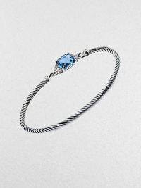 From the Petite Wheaton Collection. A faceted pillow of richly hued blue topaz, edged with diamonds and set on a classic sterling silver cable bangle.Diamonds, 0.08 tcwBlue topazSterling silverDiameter, about 2½3mm cableHook claspImported