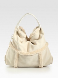 Luxurious dyed shearling in a soft and slouchy design.Double top handles, 6 dropMagnetic top closureOne inside zip pocketTwo inside open pocketsFully lined16W X 13H X 9DImported