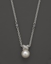 A cultured freshwater pearl is detailed in sparkling diamonds, strung on a sterling silver chain on Lagos' Luna necklace.