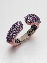 A colorful piece encrusted with a mix of faceted amethyst and multi-colored sapphire stones set in rhodium-plated sterling silver and accented with bright enamel. AmethystMulti-colored sapphiresEnamelRhodium-plated sterling silverDiameter, about 2.2Hinged closureImported 