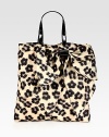 A roomy shape of sturdy nylon in a sexy leopard print, complete with a front bow and patent leather top handles. Double patent leather top handles, 6½ dropMagnetic snap closureOne inside zip pocketCotton lining13½W X 14½H X 1¾DMade in Italy