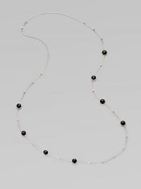 A long sterling silver chain with hammered bead and faceted onyx stations.Onyx Sterling silver Length, about 38 Lobster clasp closure Imported 