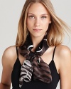 A long silk scarf with a whimsical print of floating gancinis and ombré animal print.