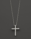 Diamonds, set in 14K white gold, form a chic cross.