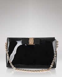 A signature grosgrain bow lends polished sophistication to Salvatore Ferragamo's glossy patent leather mini bag.