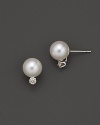 Diamonds add sparkle to shimmering pearl studs set in white gold.