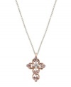 Express your faith with subtle, feminine flair. Vatican pendant features an intricate, scrolling cross highlighted with beautiful violet crystals. Setting and chain crafted in silver tone and rose gold tone mixed metal. Approximate length: 24 inches. Approximate drop: 1-1/4 inches.