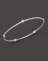 From the Silver collection, a five-diamond hammered bangle in sterling silver. Designed by Ippolita.