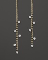 Faceted diamonds punctuate slim 14K yellow gold drops. By Meira T.