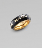 A simple band of black enamel displays the designer's imprint in raised golden letters. Enamel Brass Width, about ¾ Adjusts from Size 6 to Size 8 Imported