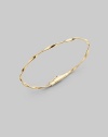 Simply stunning, this 18k gold bangle with delicate ridges and twists is great on its own, even better when stacked in multiples. 18k goldDiameter, about 2½Tongue-and-groove claspImported Please note: Bracelets sold separately. 