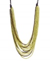 Whisk yourself away with this exotic style. Kenneth Cole New York's African-inspired necklace features multiple rows of bright lime green and brown seed beads. Set in gold-plated mixed metal and strung from brown cord. Approximate length: 22 inches + 3-inch extender. Approximate drop: 2-3/4 inches.