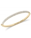 Sleek and stunning. This bangle bracelet from Michael Kors is crafted from gold ion-plated steel with glistening glass pave accents raising the style factor. Approximate diameter: 2-1/2 inches. Approximate width: 1/4 inch.