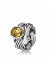 A braided band in sterling silver grounds a faceted, bezel-set bear quartz stone. Ring by PANDORA.