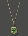 Diamonds frame a faceted peridot, set in 14K yellow gold.