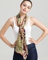 A sheer oblong scarf featuring a gorgeous tropical flora print and signature logo at hem.