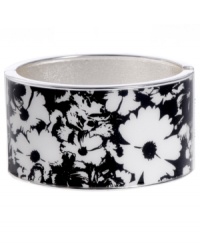 Infuse your look with the bold colors and exotic prints of Brasil. Crafted in silver tone mixed metal Haskell's Floral bangle features black and white flower details and a hinge clasp. Approximate diameter: 2-1/2 inches. Approximate length: 8 inches. Item comes packaged in a turquoise gift box.