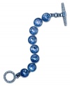 Your blue heaven. This toggle bracelet from Juicy Couture showcases round glass stones in blue hues. Finished with a toggle closure embellished with pave accents. Crafted in silver tone mixed metal. Approximate length: 7-1/2 inches.