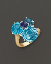 A brilliant cluster of faceted iolite, blue topaz and diamond adds bright color to gleaming 18K yellow gold. By Carelle.