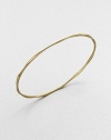 Proof that simple can be sensational, this slender gold bangle undulates elegantly.18k yellow goldDiameter, about 2.6Imported