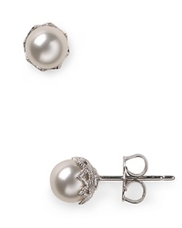 Silver set crystals surround lustrous simulated 6mm pearls to create a simply elegant silhouette. Wear this pair of Nadri stud earrings for have-forever glamour.