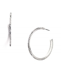 Polish your look with effortless sparkle. Nine West's three-quarter hoop earrings feature seamless sparkle in glass crystals. Crafted in silver tone mixed metal. Approximate diameter: 1-1/2 inches.