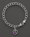 A faceted purple crystal heart charm decorates a classic bracelet from Judith Ripka.