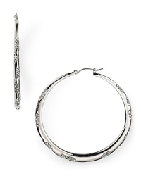 Sparkle and shine in these ABS by Allen Schwartz silver hoop earrings featuring scattered crystal stones that will light up the room.