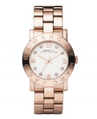 Ravishing in rose. Light up the room with the Amy watch from Marc by Marc Jacobs. Rose gold ion-plated stainless steel bracelet and round case. Bezel embossed with logo. White dial features rose-gold tone numerals at twelve, three, six and nine o'clock, crystal accents at markers, three hands and text logo. Quartz movement. Water resistant to 30 meters. Two-year limited warranty.