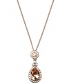 Add a regal touch to any look in Givenchy's silk teardrop pendant. Crafted from brown gold tone mixed metal, necklace incorporates shimmering topaz and clear-colored crystals. Approximate length: 16 inches + 2-inch extender. Approximate drop: 1-1/2 inches.