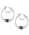 Shimmering beads lend a chic look to these classic hoops. This Nine West design highlights blue plastic beads and silver tone rondelles embellished with crystal stones. Crafted in imitation rhodium-plated mixed metal. Approximate drop: 1-1/4 inches. Approximate diameter: 1 inch.