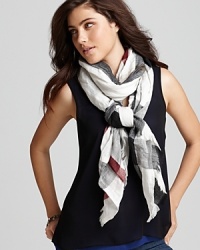 In the brand's signature palette, this crinkled, check printed scarf from Burberry lends lightweight luxe.