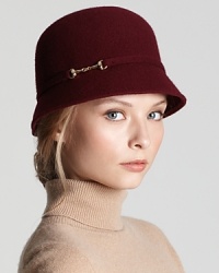 An equestrian-inspired gold buckle lends on-trend sophistication to this classic cloche from Aqua.